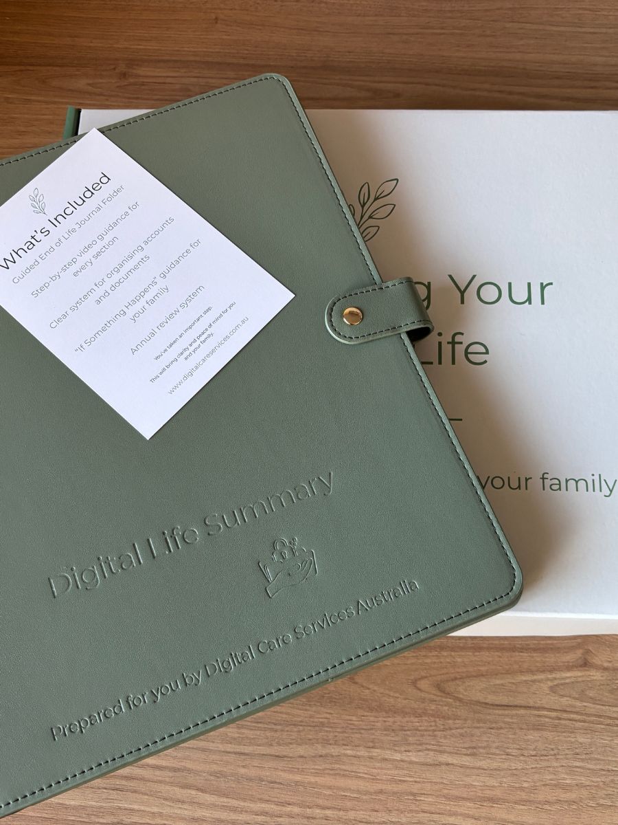 An olive green leather-bound 'Digital Life Summary' notebook cover by Digital Life Services, displayed on a wooden surface next to its white branded box and an included 'What's included' card.